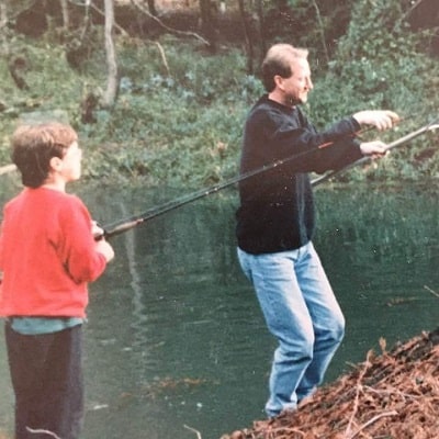 A picture of Young Cameron Britton fishing with his dad.